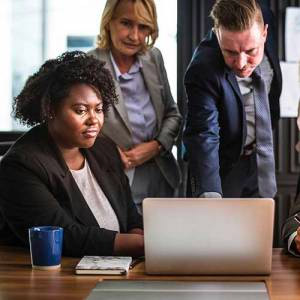 Man Speaking with group with computer