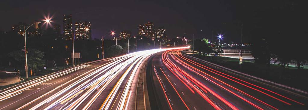 timelapse photo of traffic at night covered with public transportation insurance