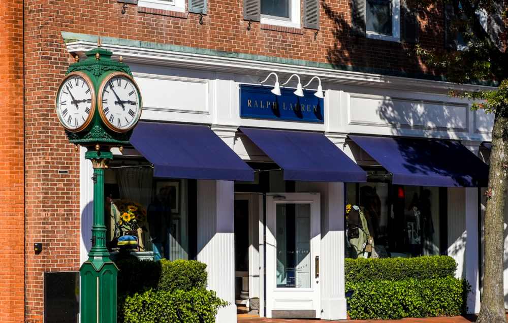 NEW CANAAN, CT, USA - OCTOBER 22, 2022: Brick building facade with Ralph Lauren store front and town clock
