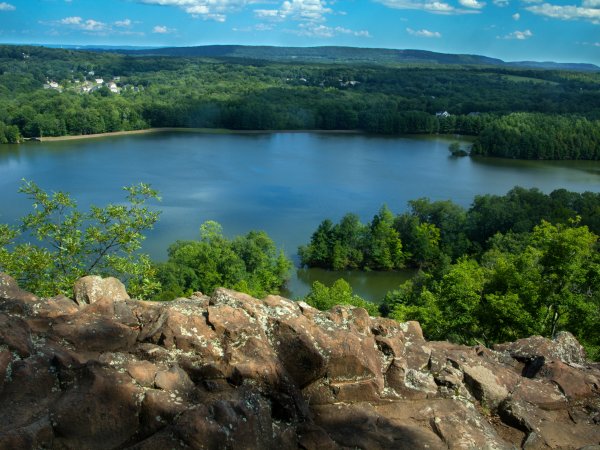 Hart Ponds below ridge of Ragged Mountain in Berlin, Connecticut. Reddish volcanic rocks typical of the Metacomet Ridge are in the foreground.