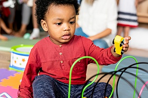 a child playing with toys at a daycare