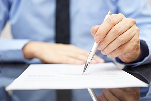 Business man looking over contract 