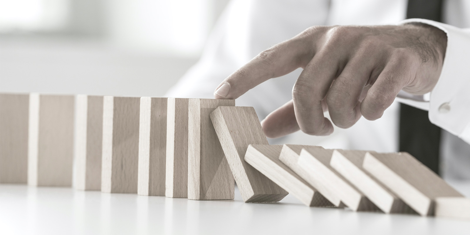 Hand stopping blocks falling over