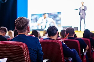 Man sitting in crowd at special business event