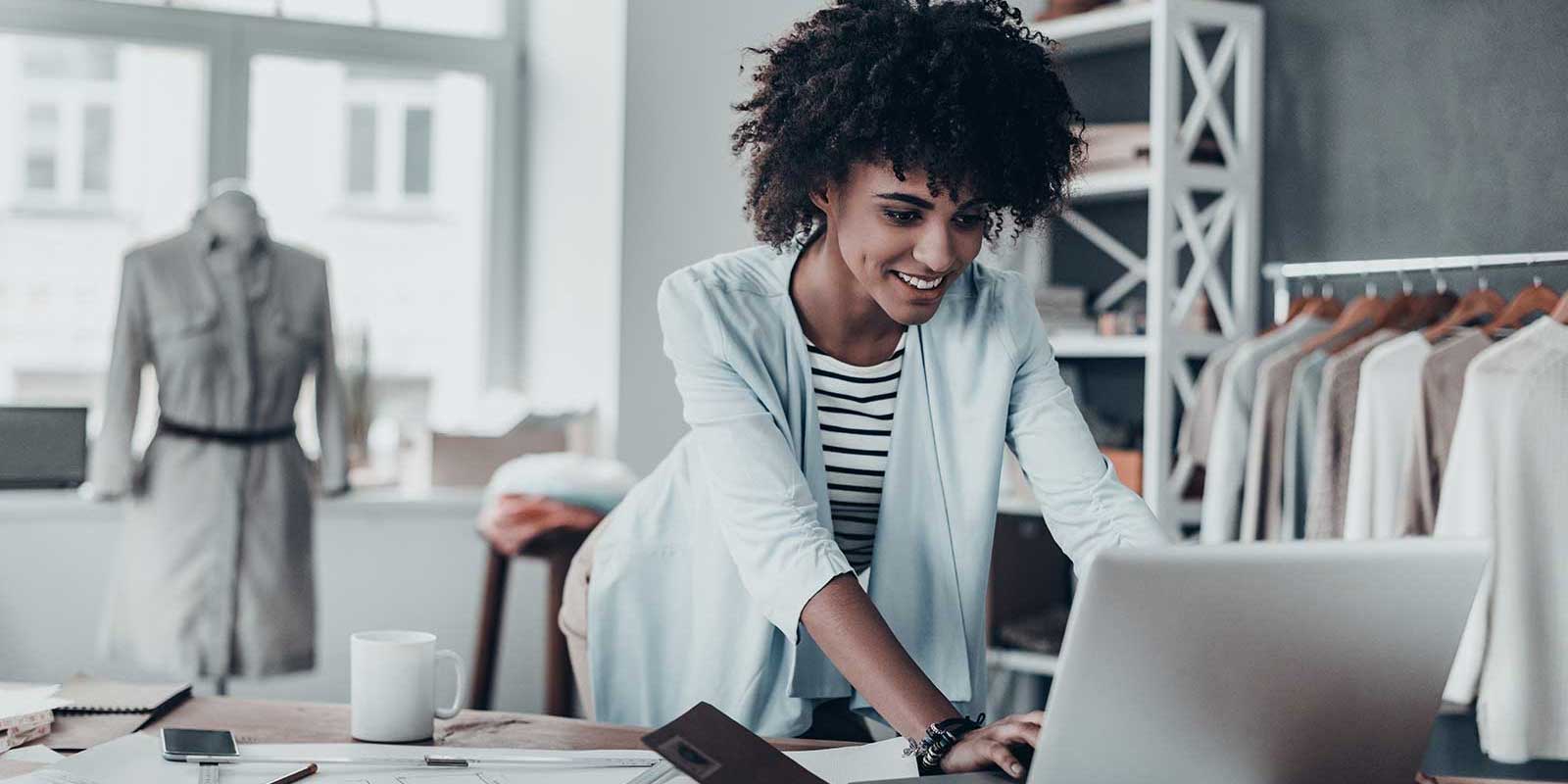 Woman business owner on her computer who is covered by a business owners policy