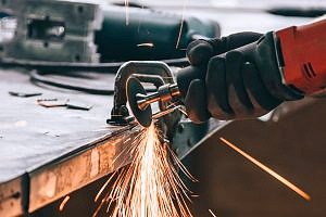 employee being careful while using drill to avoid liability