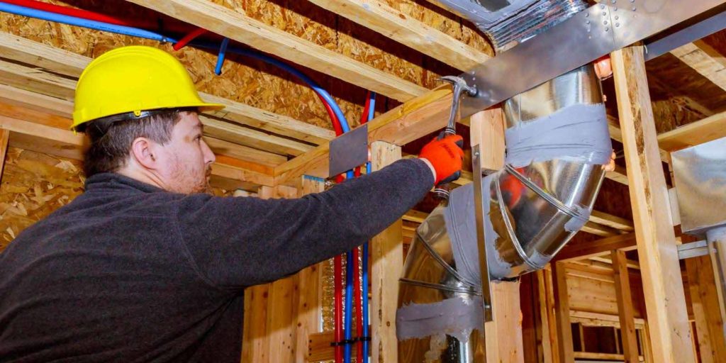 Contractor hammering wall