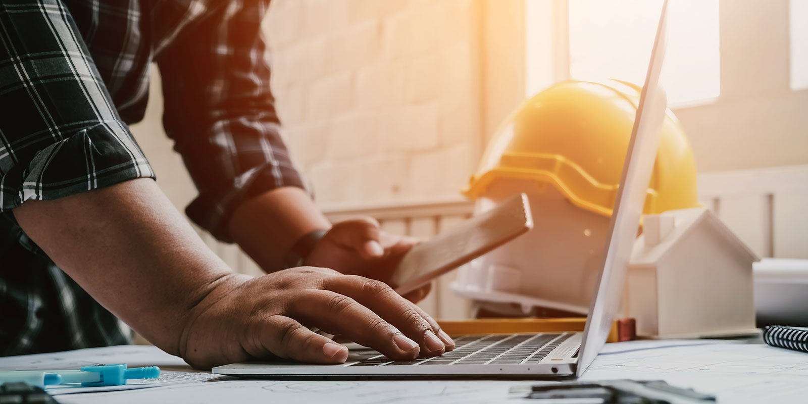 man on computer looking up cost of contractors insurance