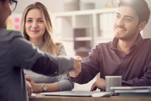 couple shaking hand of consultant after knowing What Is Personal Insurance