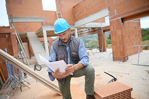 Contractor looking at his mapped out plan