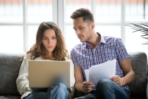 couple looking at their account for personal insurance