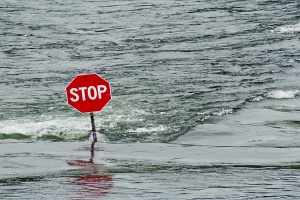 a stop sign on a street of building that have Commercial Flood Insurance