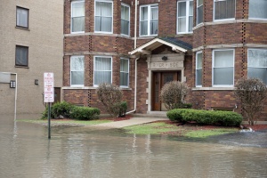 outside of a flooded building the needs Commercial Flood Insurance