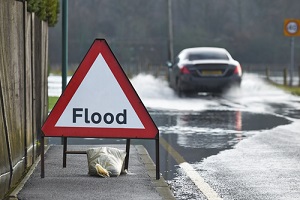 Flood Signboard Near Road needing commercial flood insurance