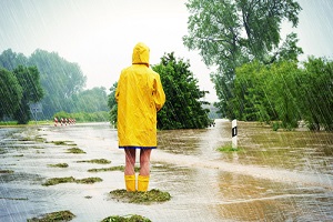 Women Standing in the Raincoat needing commercial flood insurance