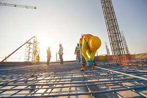 construction workers fabricating steel reinforcement bar at the construction site with course of construction insurance