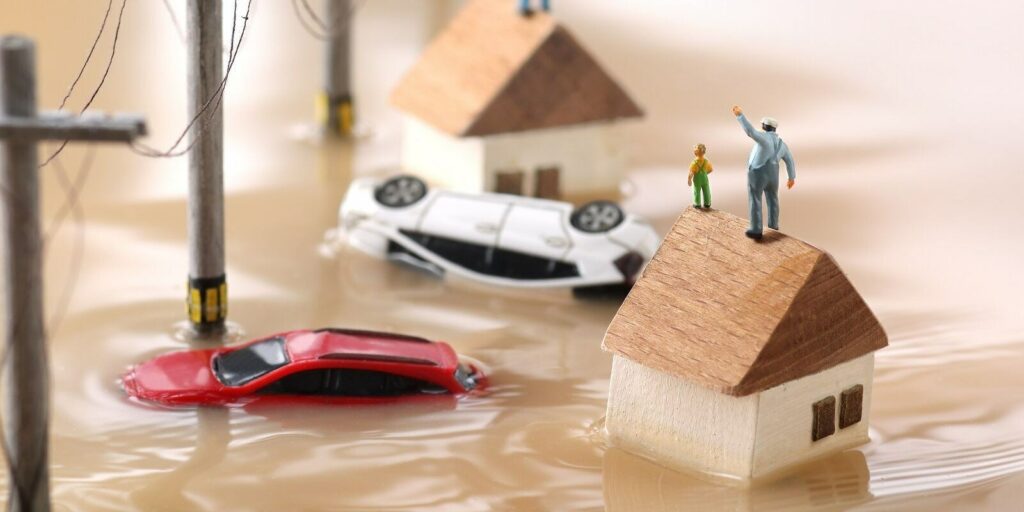 landscape of houses flooded by floods and people waiting for rescue