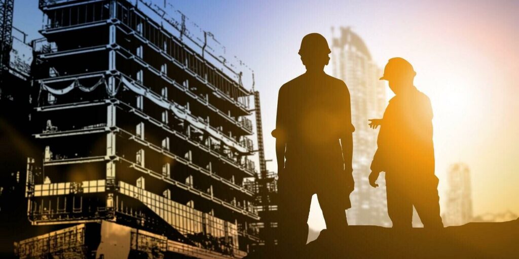 engineer looking blueprint in a building site over Blurred construction site