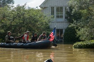 flood rescue team looking at a house