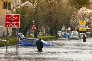 people wading through flood water on treforest industrial estate
