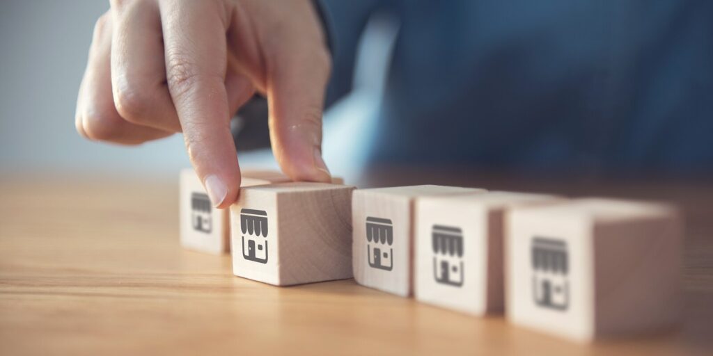 woman hand choose wood blog with franchise icon