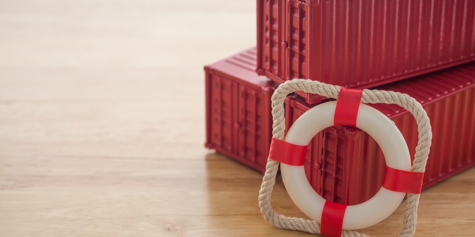 lifebuoy with red containers on wooden table