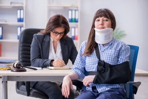 An injured woman employee consulting lawyer for general liability insurance