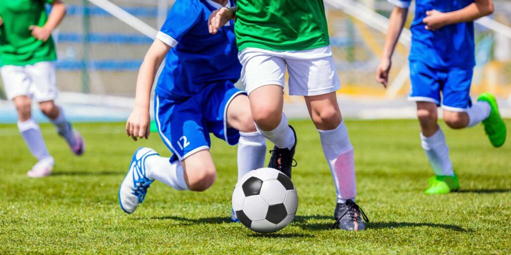 Four kids playing soccer