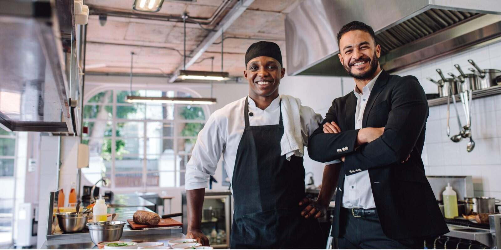 restaurant owner with chef in kitchen