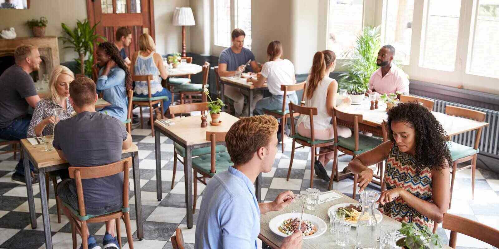 customers enjoying meals in busy restaurant