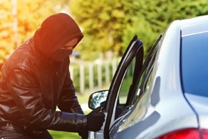 man in mask stealing the car