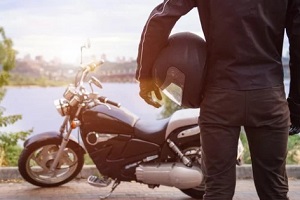 man with helmet standing near bike