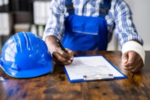 contractor signing form with hand injured