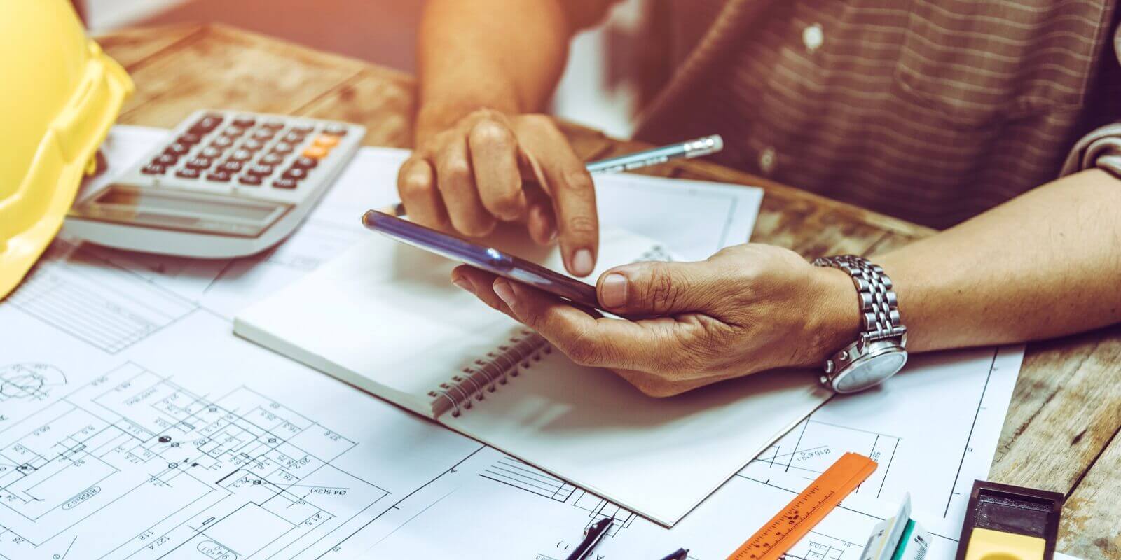 engineer contractor using phone at site working
