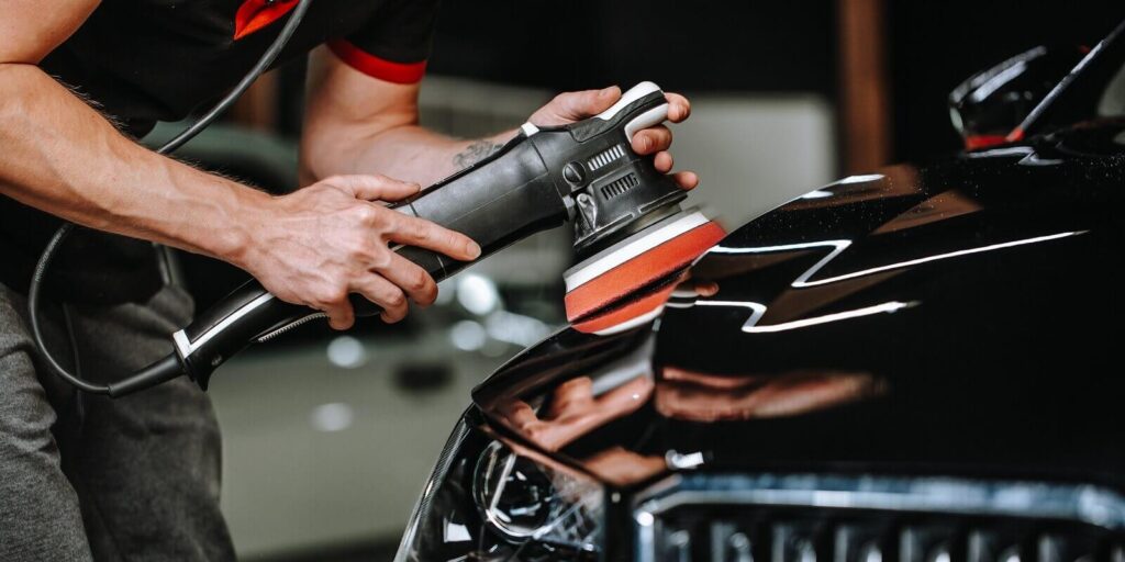 professional detailing a car in car studio