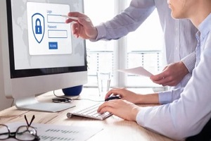 man logging in on computer