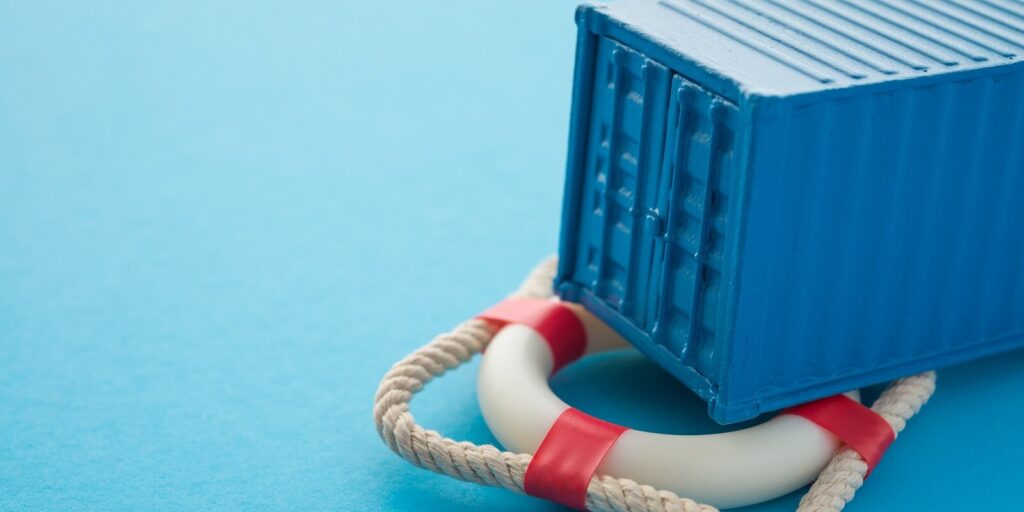 container on lifebuoy blue background with copy space