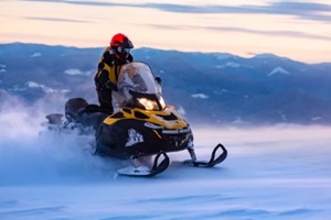 man riding snowmobile