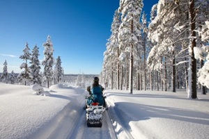 women riding a snowmobile
