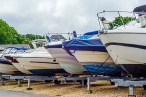 boat on stand on the shore, close up on the part of the yacht, luxury ship, maintenance and parking place boat