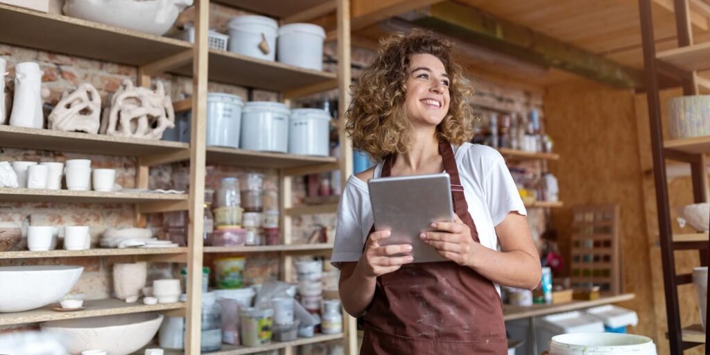 craftswoman with tablet computer in art studio
