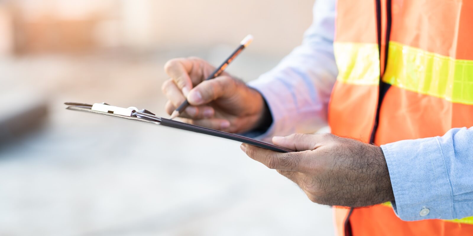 asian inspector checking structure of new property and taking note in the clipboard for review and fix the house before sell to client
