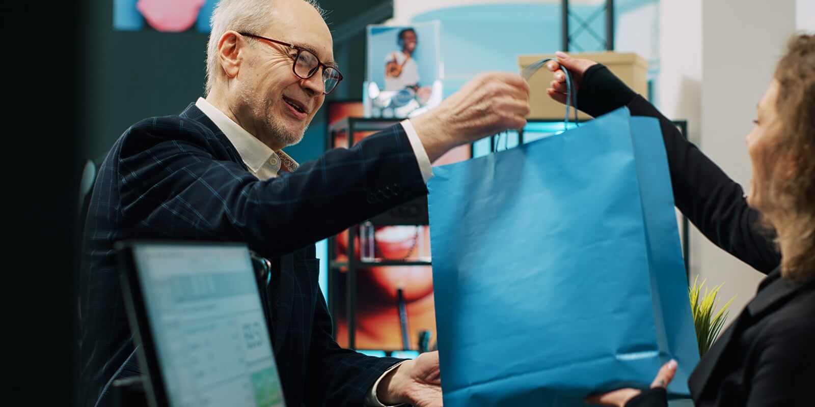 checkout staff selling clothing items to senior customer in shopping mall