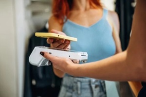 women paying with nfc at a retail store