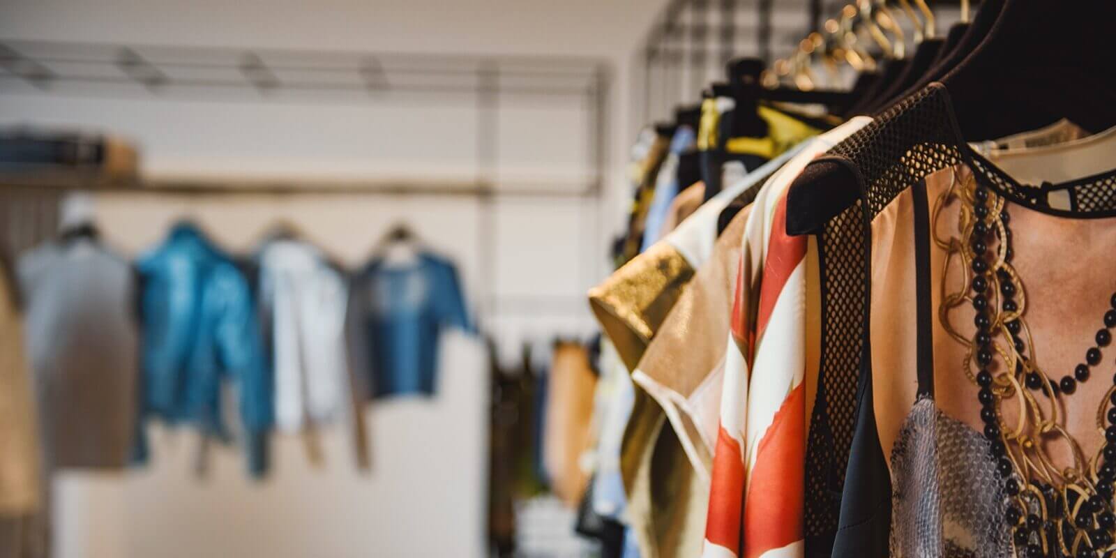 clothes on hangers in a retail shop