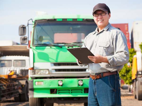 happy truck driver writing on a document