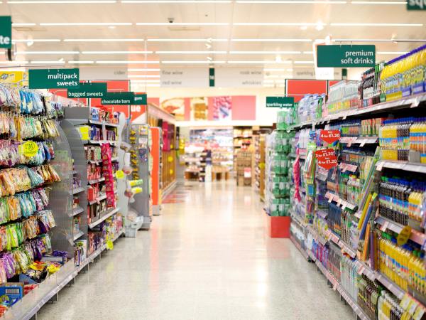 aisles of stocked selves in supermarket