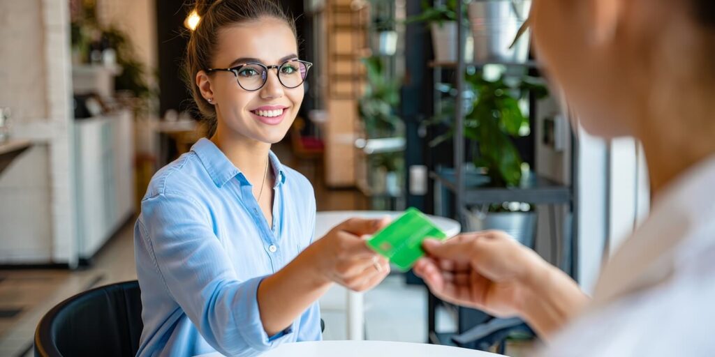 woman paying with credit card at cafe restaurant for coffee and food purchase now