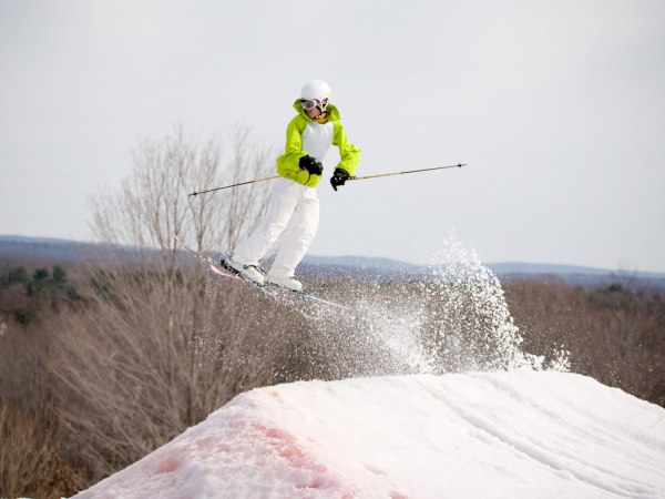 A skier catching some major air after launching off of a jump.
