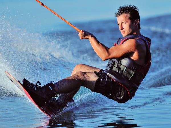 Wakeboarder surfing across a lake